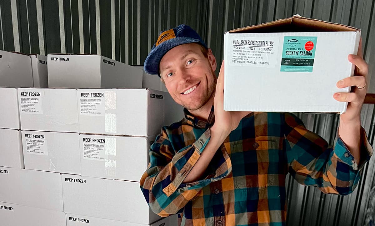 Man holding box of fish